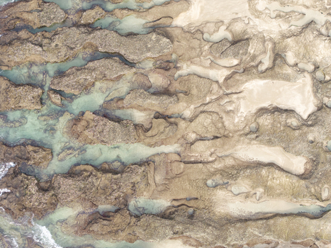 Aerial view of the rocky coastline of Hartenbos featuring intricate tide pools and clear turquoise water Mossel Bay Western Cape South Africa. Aerial view of the rocky coastline of Hartenbos featuring intricate tide pools and clear turquoise water Mossel Bay Western Cape South Africa.