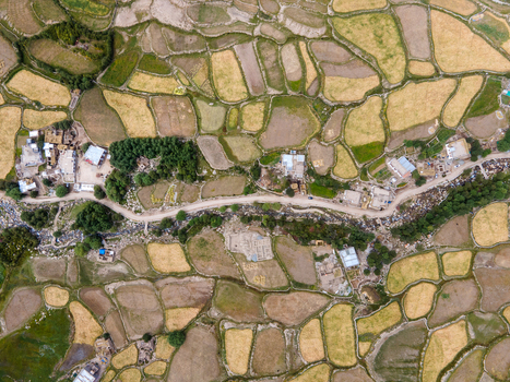 Aerial view of agricultural fields and small village settlements nestled in the mountainous landscape of Ladakh Division Ladakh India. Aerial view of agricultural fields and small village settlements nestled in the mountainous landscape of Ladakh Division Ladakh India.