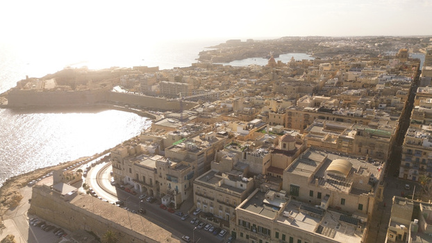 Aerial view of the historic city of Valletta with its dense limestone buildings narrow streets and fortifications overlooking the Mediterranean Sea in Valletta Port Region Malta. Aerial view of the historic city of Valletta with its dense limestone buildings narrow streets and fortifications overlooking the Mediterranean Sea in Valletta Port Region Malta.