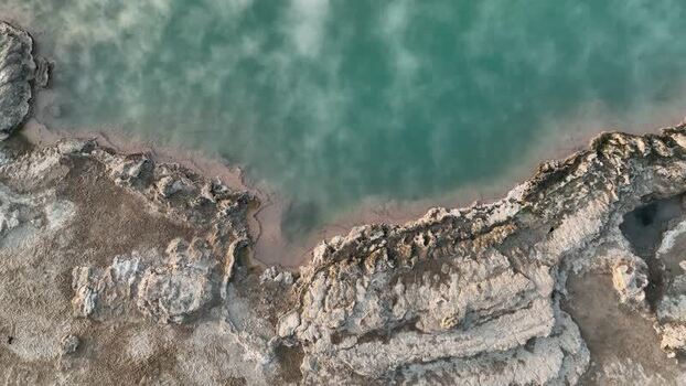 Aerial view of turquoise geothermal pool in Danakil Desert Ethiopia. Aerial view of turquoise geothermal pool in Danakil Desert Ethiopia.
