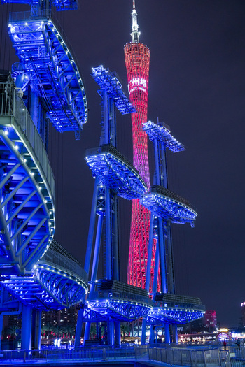 Guangzhou Guangdong Province China 23 February 2024 View of the illuminated Canton Tower at night with vibrant blue architectural structures in the foreground. Guangzhou Guangdong Province China 23 February 2024 View of the illuminated Canton Tower at night with vibrant blue architectural structures in the foreground.