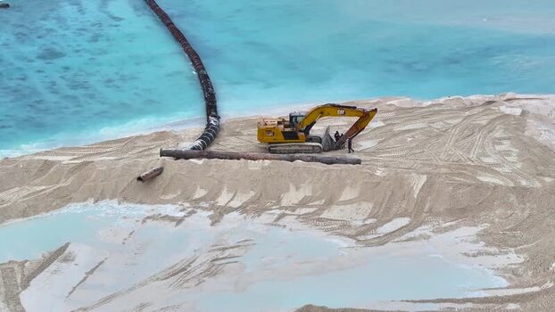 Aerial view of an excavator working on beach reclamation Maldives.