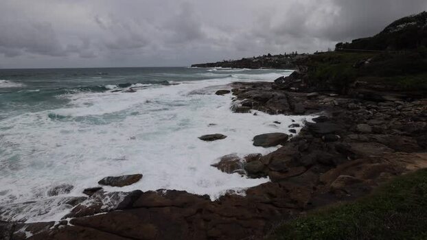 View of Bondi Beach coastline with crashing waves in Australia.