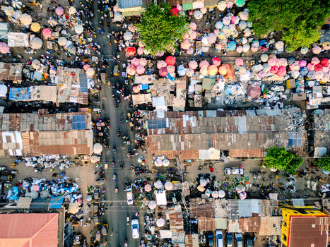 Aerial view of the bustling Panteka Market with colorful umbrellas crowded streets and rusty corrugated rooftops Kaduna Kaduna Nigeria. Aerial view of the bustling Panteka Market with colorful umbrellas crowded streets and rusty corrugated rooftops Kaduna Kaduna Nigeria.