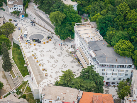 Aerial view of Cerciz Topulli Square with traditional stone patterns on the pavement historic buildings and people walking Gjirokaster Gjirokaster County Albania. Aerial view of Cerciz Topulli Square with traditional stone patterns on the pavement historic buildings and people walking Gjirokaster Gjirokaster County Albania.