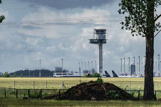 Berlin Berlin Germany 13 June 2026 View of the control tower and parked aircraft at the ILA Berlin Air Show with a grassy field in the foreground under a cloudy sky. Berlin Berlin Germany 13 June 2026 View of the control tower and parked aircraft at the ILA Berlin Air Show with a grassy field in the foreground under a cloudy sky.