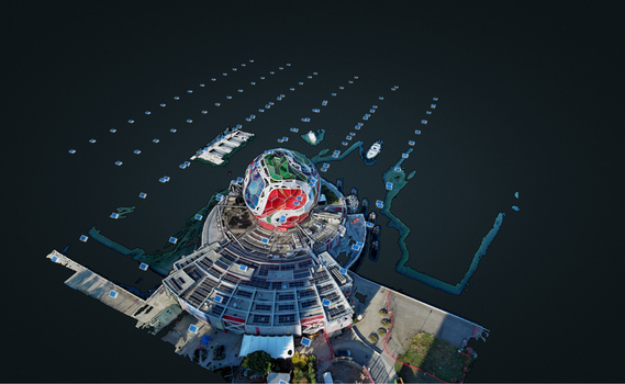 Aerial view of a spherical architectural structure with a circular base surrounded by water and floating markers in a 3D model rendering in Richmond British Columbia Canada. Aerial view of a spherical architectural structure with a circular base surrounded by water and floating markers in a 3D model rendering in Richmond British Columbia Canada.