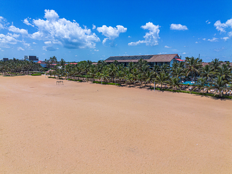 Aerial view of Negombo Beach with a tropical resort nestled among lush palm trees along the sandy coastline in Negombo Western Province Sri Lanka. Aerial view of Negombo Beach with a tropical resort nestled among lush palm trees along the sandy coastline in Negombo Western Province Sri Lanka.