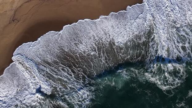 Aerial view of beach meeting ocean Portugal.