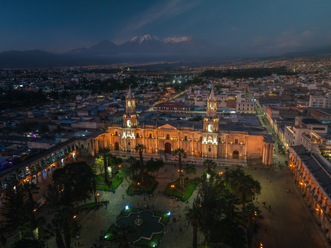 Aerial view of Arequipa Cathedral illuminated at night overlooking the Plaza de Armas with colonial architecture and the Misti volcano in Arequipa Arequipa Peru. Aerial view of Arequipa Cathedral illuminated at night overlooking the Plaza de Armas with colonial architecture and the Misti volcano in Arequipa Arequipa Peru.