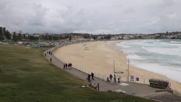 View of Bondi Beach with people walking along the promenade Australia.