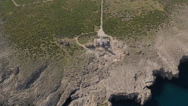 Aerial view of the Plemmirio lighthouse on rocky cliffs Italy.