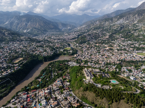 Aerial view of Muzaffarabad city nestled in the mountains featuring the confluence of rivers dense urban housing and lush green hillsides in Muzaffarabad Azad Kashmir Pakistan. Aerial view of Muzaffarabad city nestled in the mountains featuring the confluence of rivers dense urban housing and lush green hillsides in Muzaffarabad Azad Kashmir Pakistan.