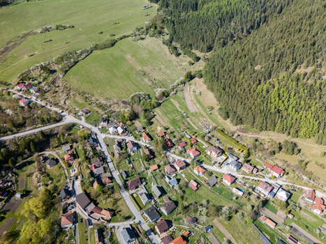 Aerial view of the village of Valaska Dubova featuring traditional houses nestled between green fields and a dense forest in Valaska Dubova Zilina Region Slovakia. Aerial view of the village of Valaska Dubova featuring traditional houses nestled between green fields and a dense forest in Valaska Dubova Zilina Region Slovakia.