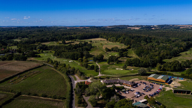 Aerial view of Hamptworth Golf course with green fairways sand bunkers clubhouse parking lot and surrounding woodland in Hamptworth England United Kingdom. Aerial view of Hamptworth Golf course with green fairways sand bunkers clubhouse parking lot and surrounding woodland in Hamptworth England United Kingdom.