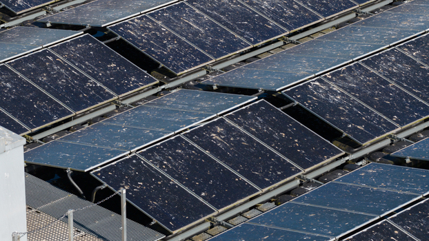 Aerial view of solar panels covered in bird droppings and dirt on a rooftop in Zwolle Overijssel Netherlands. Aerial view of solar panels covered in bird droppings and dirt on a rooftop in Zwolle Overijssel Netherlands.