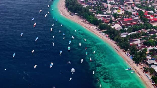 Aerial view of boats along the sandy coastline of Bali Indonesia.