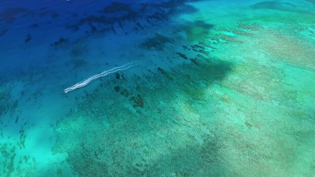 Aerial view of Grand Cayman coral reefs and boat Cayman Islands. Aerial view of Grand Cayman coral reefs and boat Cayman Islands.