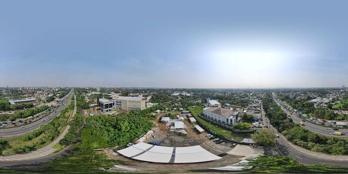 Aerial view of Bambu Apus area featuring a white canopy structure surrounding buildings lush greenery and busy highways in Kecamatan Cipayung Daerah Khusus Ibukota Indonesia. Aerial view of Bambu Apus area featuring a white canopy structure surrounding buildings lush greenery and busy highways in Kecamatan Cipayung Daerah Khusus Ibukota Indonesia.