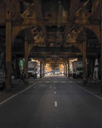 Chicago United States 15 September 2025 View of the iconic elevated train tracks with industrial steel girders and distant city traffic on a street in the downtown area.