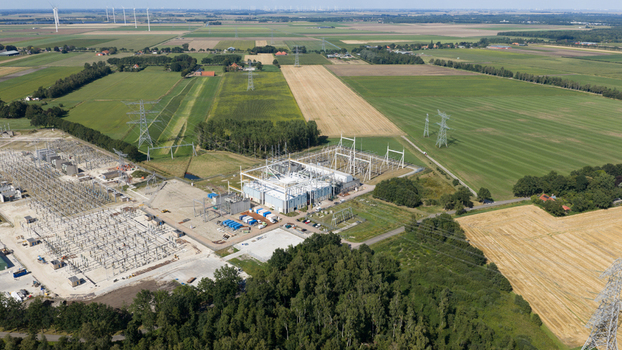 Meeden Groningen Netherlands 25 August 2026 Aerial view of the high voltage substation surrounded by agricultural fields green meadows and wind turbines under a clear sky. Meeden Groningen Netherlands 25 August 2026 Aerial view of the high voltage substation surrounded by agricultural fields green meadows and wind turbines under a clear sky.