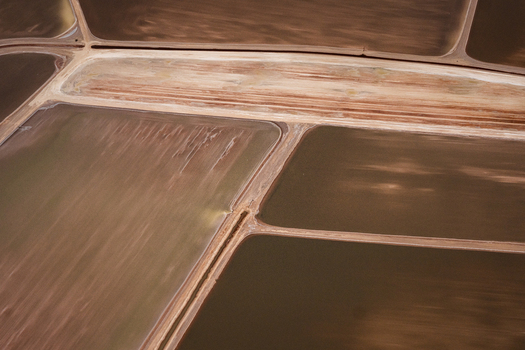 Aerial view of industrial salt mine evaporation ponds with textured brown and yellow earth patterns in Kalbarri Western Australia Australia. Aerial view of industrial salt mine evaporation ponds with textured brown and yellow earth patterns in Kalbarri Western Australia Australia.