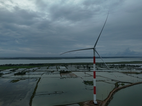 Aerial view of the Khurushkul wind turbine standing in a flooded coastal landscape under a cloudy sky in Cox s Bazar Chittagong Division Bangladesh. Aerial view of the Khurushkul wind turbine standing in a flooded coastal landscape under a cloudy sky in Cox s Bazar Chittagong Division Bangladesh.