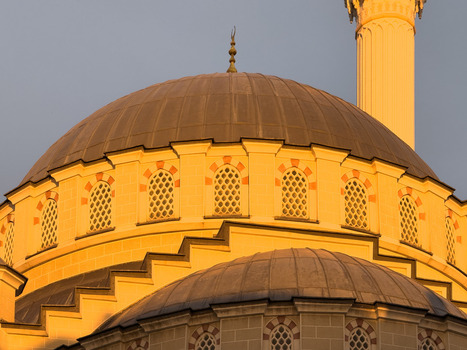 View of the ornate dome and minaret of a mosque during golden hour in Avcilar Istanbul Turkiye. View of the ornate dome and minaret of a mosque during golden hour in Avcilar Istanbul Turkiye.
