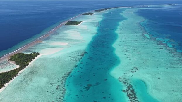 Aerial view of a tropical atoll and coral reefs Maldives.