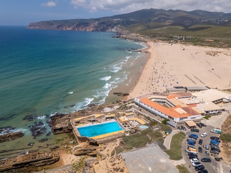 Aerial view of Praia do Guincho featuring the swimming pool sandy beach rocky coastline and Atlantic Ocean in Cascais Lisbon Portugal. Aerial view of Praia do Guincho featuring the swimming pool sandy beach rocky coastline and Atlantic Ocean in Cascais Lisbon Portugal.