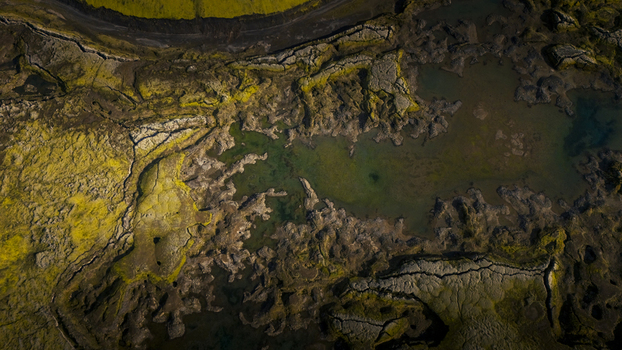 Aerial view of the vibrant green moss and dark black volcanic sand landscape surrounding the pools of Langisjor in Vik Myrdalshreppur Iceland. Aerial view of the vibrant green moss and dark black volcanic sand landscape surrounding the pools of Langisjor in Vik Myrdalshreppur Iceland.