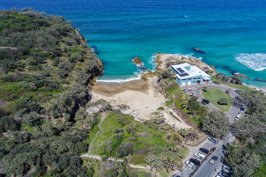 Aerial view of North Stradbroke Island featuring the turquoise waters of Cylinder Beach rocky headlands and coastal vegetation in Redland City Queensland Australia. Aerial view of North Stradbroke Island featuring the turquoise waters of Cylinder Beach rocky headlands and coastal vegetation in Redland City Queensland Australia.