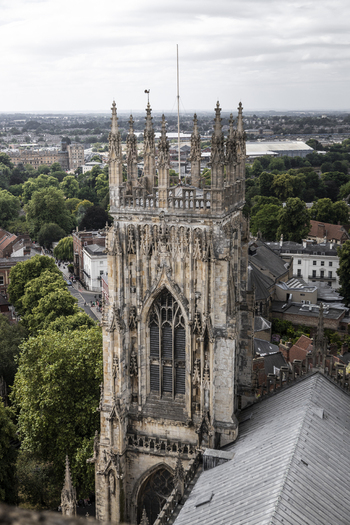Aerial view of York Minster with its intricate gothic stone architecture towering central tower and surrounding historic city rooftops in York England United Kingdom.