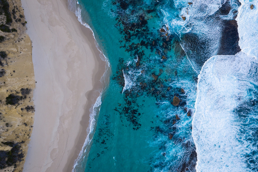 Aerial view of Two Peoples Bay Nature Reserve featuring turquoise ocean waters white sand beach and rocky coastline in Albany Western Australia Australia.