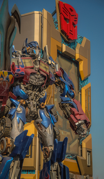 View of the Optimus Prime statue standing in front of a Transformers themed building with the Autobot logo at Universal Studios Beijing in Beijing Beijing China.
