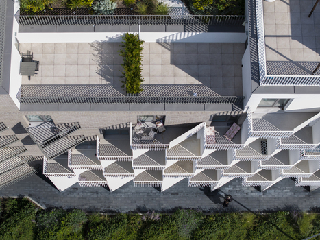 Aerial view of modern building with geometric balcony patterns rooftop terrace and lush greenery in Krakow Lesser Poland Voivode Poland.