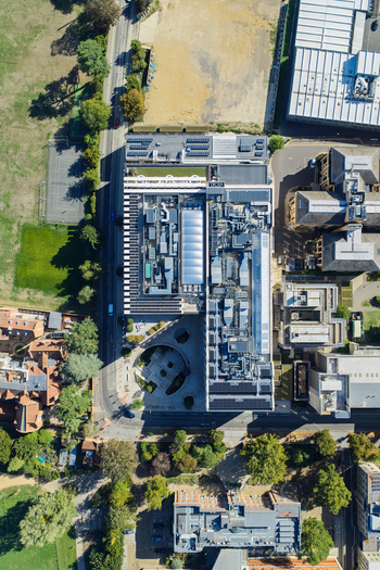 Aerial view of the Data Center at Oxford University featuring modern rooftop equipment solar panels and a circular courtyard surrounded by green spaces in Oxford England United Kingdom. Aerial view of the Data Center at Oxford University featuring modern rooftop equipment solar panels and a circular courtyard surrounded by green spaces in Oxford England United Kingdom.