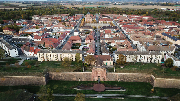 Aerial view of the historic Vauban walled city of Neuf Brisach with its distinctive octagonal layout red tiled rooftops and surrounding fortifications in Neuf Brisach Grand Est France. Aerial view of the historic Vauban walled city of Neuf Brisach with its distinctive octagonal layout red tiled rooftops and surrounding fortifications in Neuf Brisach Grand Est France.