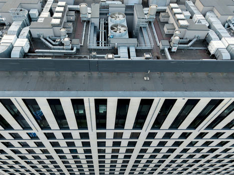 Aerial view of the AI data center cooling system on the rooftop of a modern office building with ventilation ducts and fans in Krakow Lesser Poland Voivode Poland. Aerial view of the AI data center cooling system on the rooftop of a modern office building with ventilation ducts and fans in Krakow Lesser Poland Voivode Poland.