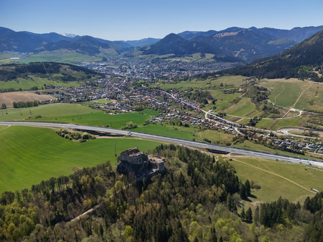Aerial view of Castle Likava ruins perched on a forested hill overlooking a highway bridge and the town valley in Likavka Zilina Region Slovakia. Aerial view of Castle Likava ruins perched on a forested hill overlooking a highway bridge and the town valley in Likavka Zilina Region Slovakia.