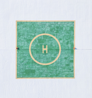 Aerial view of the helipad at the Centro Internacional de Congresos de Yucatan with its distinctive green square and central H marking set against a white surface in Merida Yucatan Mexico.