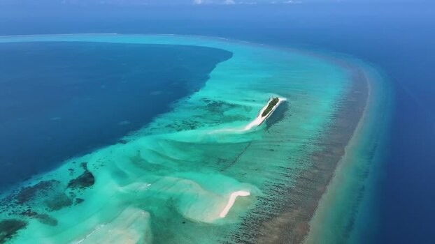 Aerial view of a tropical sandbank and coral reefs in the Maldives. Aerial view of a tropical sandbank and coral reefs in the Maldives.