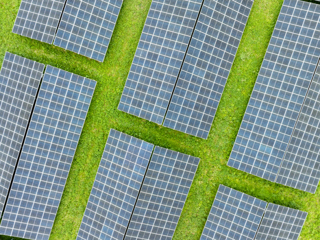 Aerial view of solar panels arranged in rows on a lush green field in Aiglsbach Bavaria Germany.