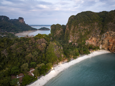 Aerial view of the beach with stunning limestone cliffs and lush green vegetation meeting the turquoise sea Krabi Thailand. Aerial view of the beach with stunning limestone cliffs and lush green vegetation meeting the turquoise sea Krabi Thailand.
