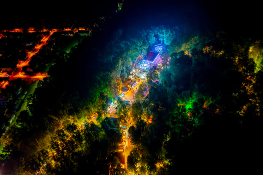 Aerial view of Annafest festival with illuminated amusement rides and stalls nestled in the forest at night Forchheim Bayern Germany. Aerial view of Annafest festival with illuminated amusement rides and stalls nestled in the forest at night Forchheim Bayern Germany.