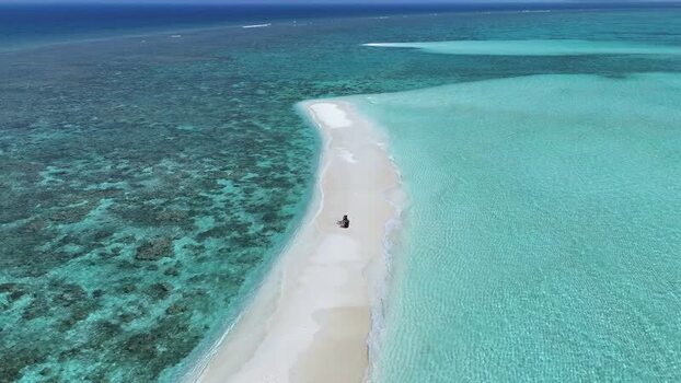 Aerial view of a person on a white sandbank in a turquoise lagoon Maldives. Aerial view of a person on a white sandbank in a turquoise lagoon Maldives.