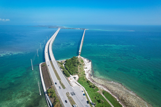 Aerial view of The Overseas Highway bridge crossing the turquoise waters of the Florida Keys with the old bridge structure alongside in Key Largo Florida United States. Aerial view of The Overseas Highway bridge crossing the turquoise waters of the Florida Keys with the old bridge structure alongside in Key Largo Florida United States.