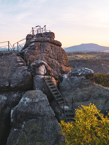 Aerial view of Popova Skala rock formation with metal stairs and observation platform at sunset in Hradek nad Nisou Liberec Region Czechia. Aerial view of Popova Skala rock formation with metal stairs and observation platform at sunset in Hradek nad Nisou Liberec Region Czechia.