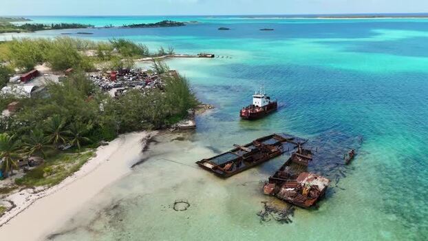 Aerial view of shipwrecks and a tugboat in George Town The Bahamas.