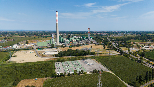 Aerial view of the TTEP Tavazzano thermal power plant and TERNA electrical substation with industrial buildings and surrounding fields in Tavazzano con Villavesco Lombardy Italy.